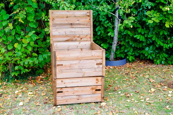 wooden garden compost bin with organic material