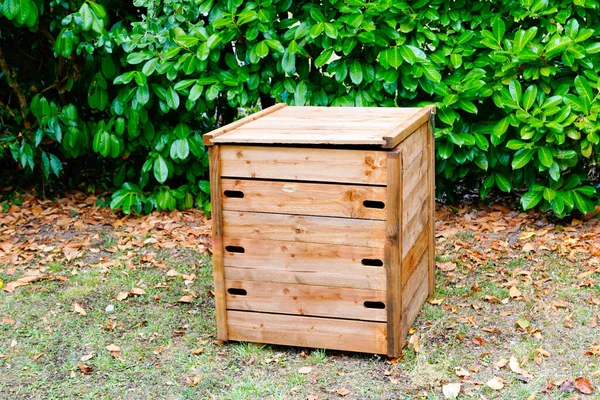 wooden garden compost bin of organic material composter