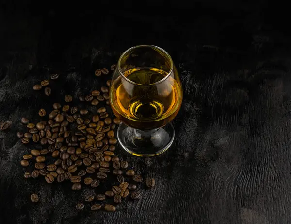 Een Glas Cognac Koffiebonen Een Donkere Houten Achtergrond — Stockfoto