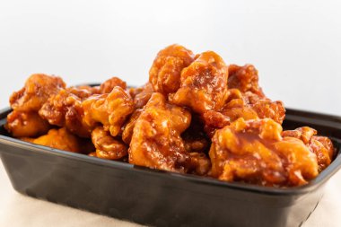 Büyük bir kase portakal aromalı tavuk tatlı sosu ve eti gösteriyor..