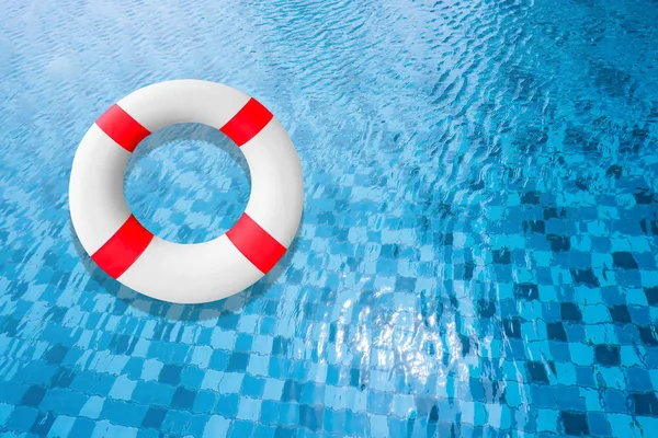 Life Buoy in a Clear Pool Water. Life Belt or Life Preserver Floating on Top of Sunny Blue Water. Safety Equipment, Blue and White Life Ring in Swimming Pool. Life Saver Object on Sea to Rescue People.