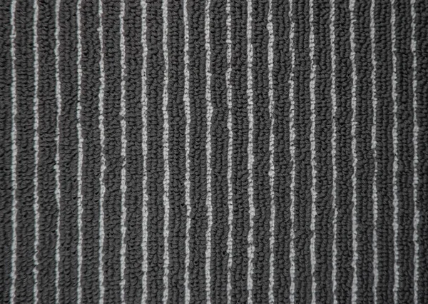 Carpet texture in office, full frame concept. Close up of monochrome grey carpet background or pattern from above. Top view. Industrial gray color fitted rug. Black mat textile of Interior element.