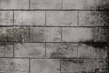 Gri tuğla duvar, tasarım için dokulu koyu taş tuğla arka plan. Kırsal odada desen ve duvar kağıdı için eski vintage beton blok duvar dokusu. İç konsept. Kaba taşın tek renkli.