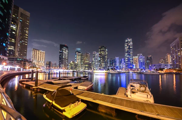 skyline of Dubai Marina at night with boats, United Arab Emirates, Middle East