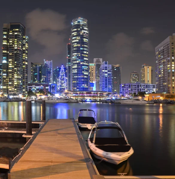 skyline of Dubai Marina at night with boats, United Arab Emirates, Middle East