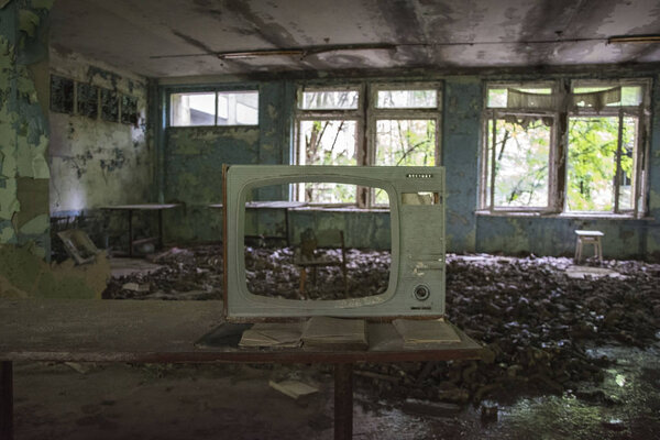 Chair and old TV in Middle School No. 3 in Pripyat ghost town, Chernobyl Nuclear Power Plant Zone of Alienation, Ukraine