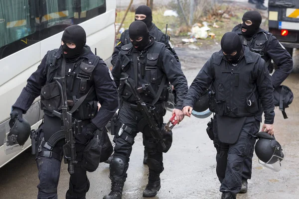 Special law enforcement unit. Special police force units in uniforms, bulletproof vests, firearms and guns. Masked police officers. Special Assault Team during mission.