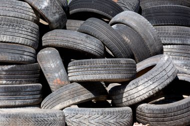 Old and used car tyres on a pile. clipart