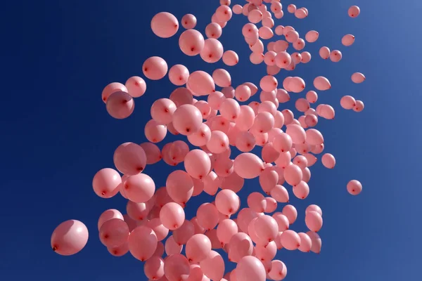 昨年の乳がんで亡くなった女性を記念して 何百ものピンク色の風船が青空に向かって放出されています — ストック写真