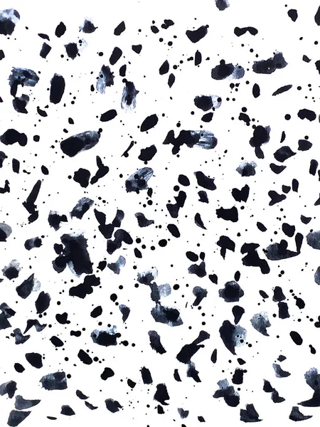 Ink spots of different sizes on a white background. Abstract black and white background.