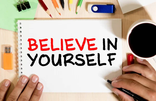 Handwriting text Believe In Yourself. Concept meaning Determination Positivity Courage Trust Faith Belief Advisors hand holding black marker whiteboard written black color words.