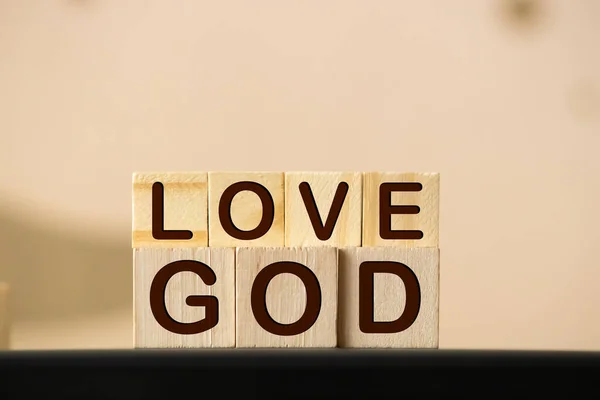 God is love concept text lying on the rustic wooden background.