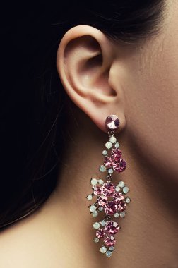 female ear with shimmering earring clipart