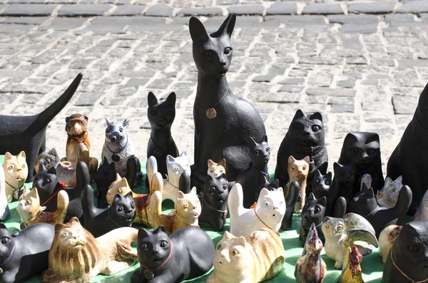 statuettes of cats on the street market