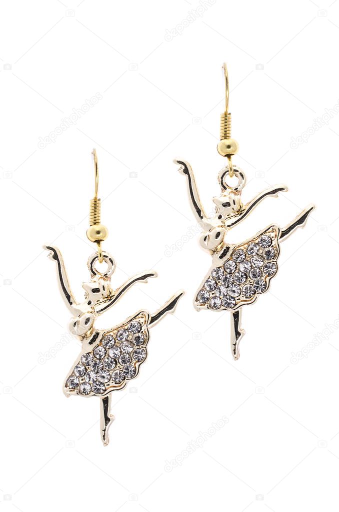 Gold earrings in the form of a ballerina   inlaid with  gemstones on a white background