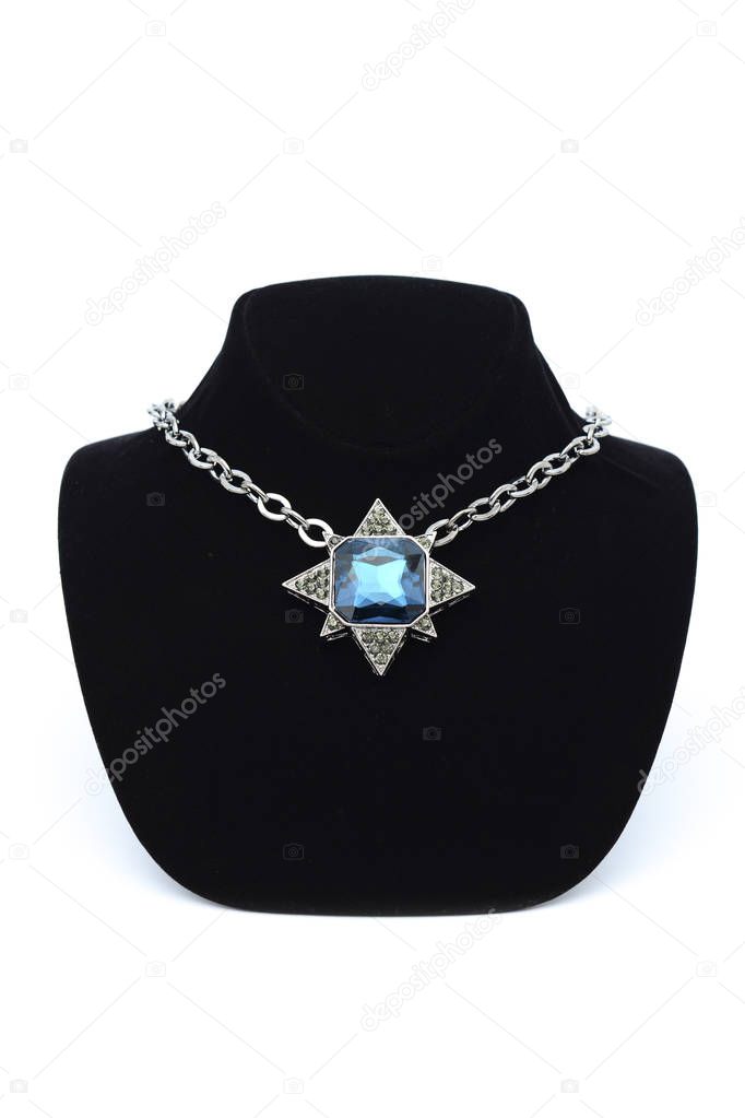 Pendant star  with blue stones on mannequin isolated on white