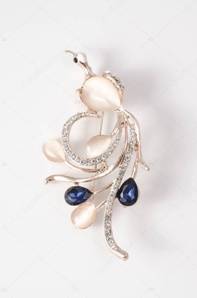 golden brooch fire bird with moon stone and diamonds isolated on white