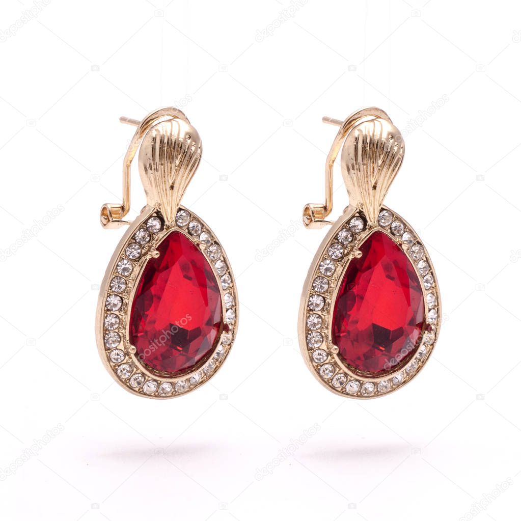 gold earrings with ruby drops isolated on white