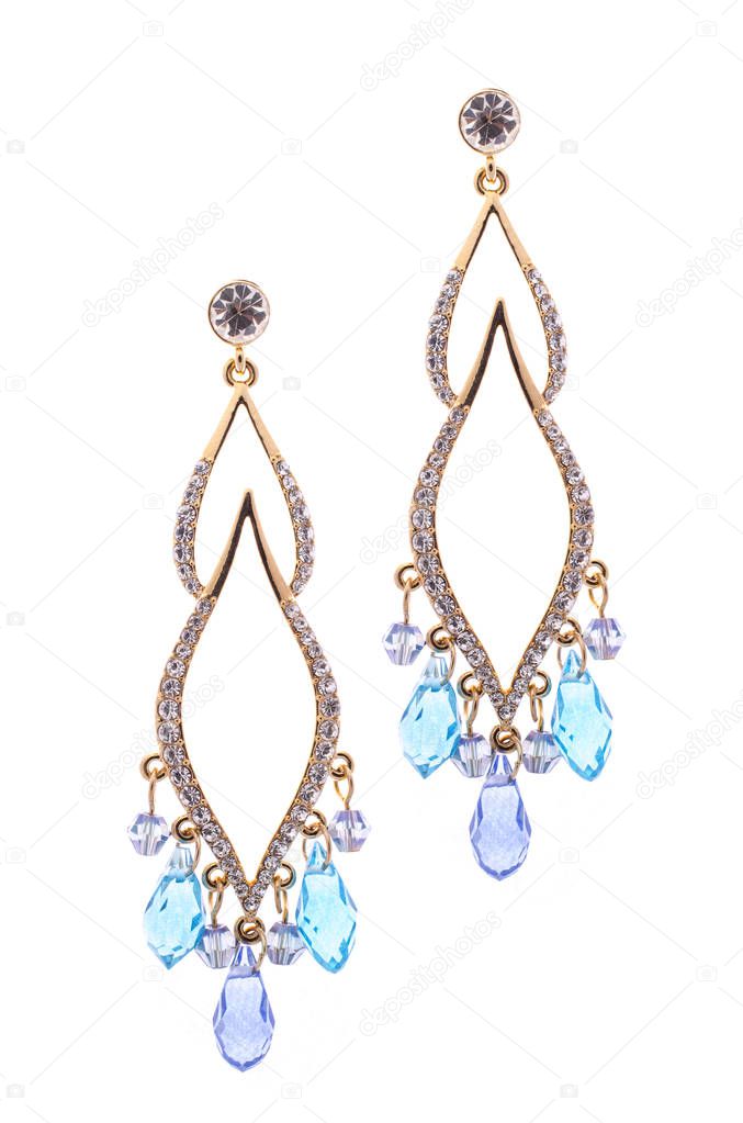 earrings inlaid with precious stones on a white background