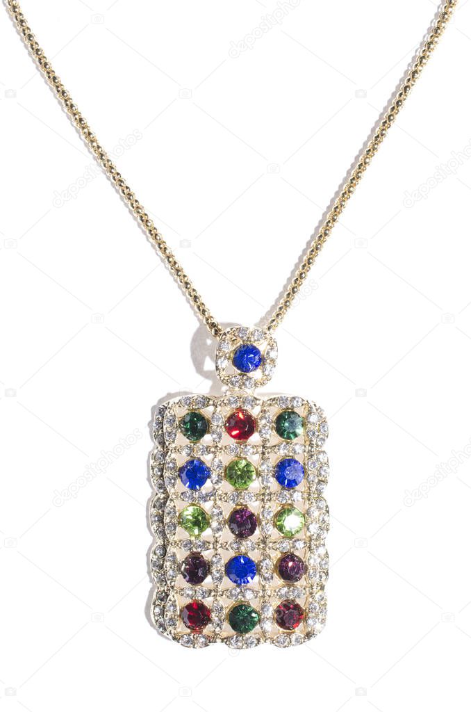 gold pendant with colored gems  on a white background