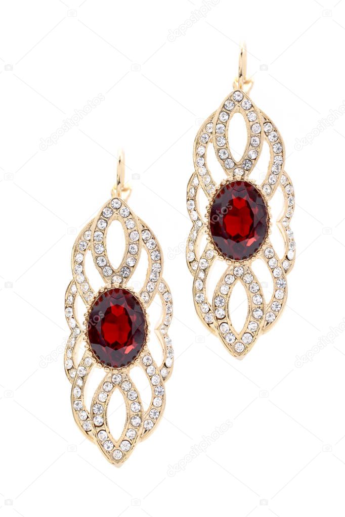 gold earrings with ruby on white background
