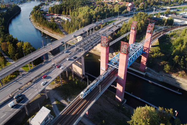 Sodertalje, Sweden - September 9, 2018: Aerial view of th two road bridges and the railroad bridge crossing the Sodertalje canal at the same location. 