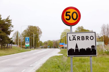 Larbro, İsveç - 15 Mayıs 2016: hız sınırı ve kasaba yol işaretleri köyü Larbro başında İsveç Gotland il içinde bulunan.