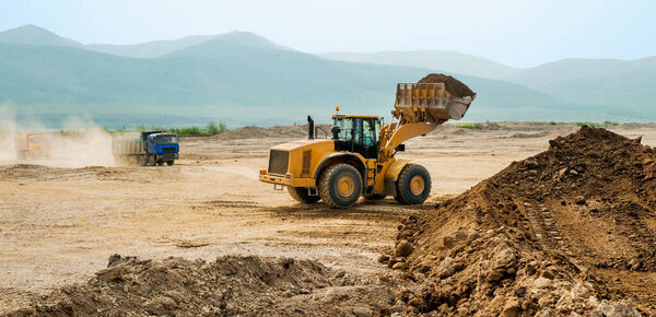 Front loader in standby mode of a haul truck. Earthworks in mountainous areas.