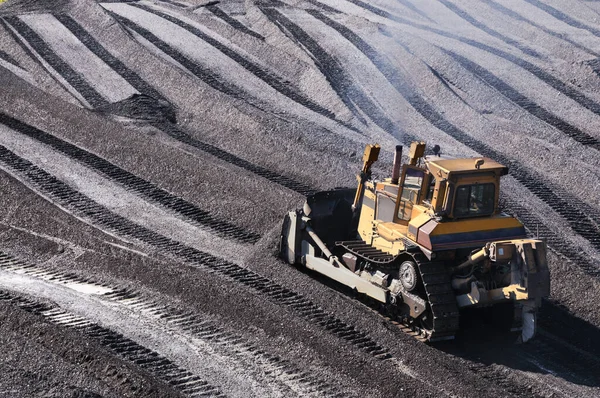 Bulldozer in mountainous area, layer by layer, remove mountain soil from the surface and shovel it to the side.