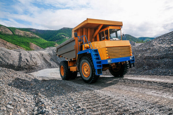 The mountainous dump truck is widely used for transporting and unloading rocks. Mining.