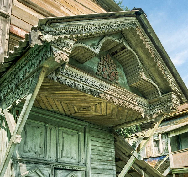 Canopy over main entrance of old wooden house from times of Russian Empire There are carved decorations on facade decor. Architecture of European part of Russia . For various reasons, these old houses are getting smaller and smaller every year.