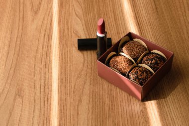 Dört tugaylı bir kutu ve güneş ışınıyla aydınlatılan bir ruj. Sağ üst tugay komutanına odaklan..