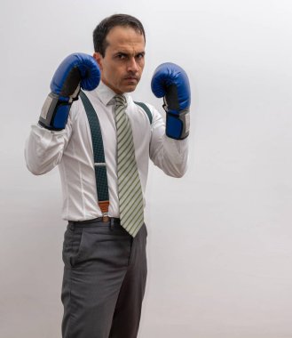 Man standing with formal clothes, suspenders, tie, boxing glove and with your guard up. clipart