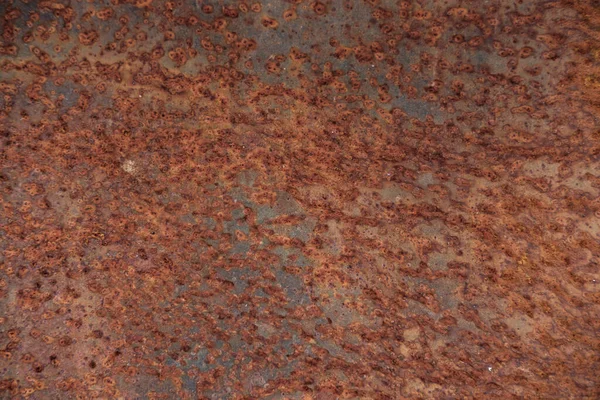 Background from rusty metal, covered with spots of brown-red color.