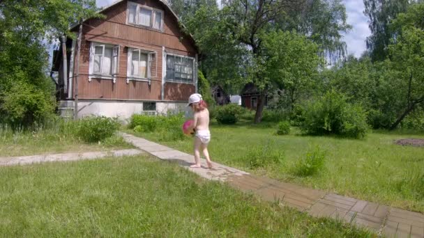 Happy Little Girl Plays Ball Water Splashes Background Village House — Stock Video