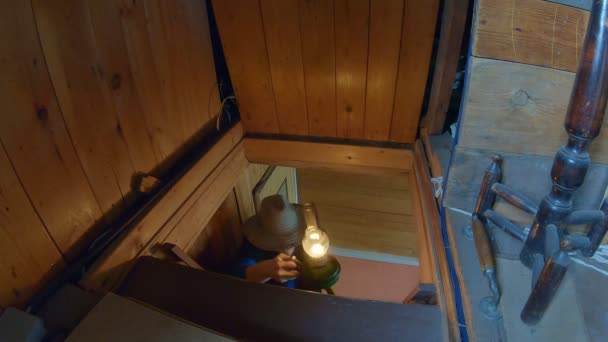 Old Wooden House Man Hat Goes Stairs Attic Axe Lamp — Stock Video