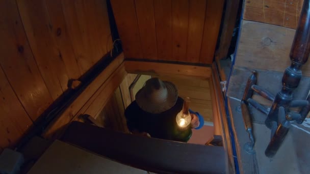 Old Wooden House Man Hat Goes Stairs Attic Axe Lamp — Stock Video