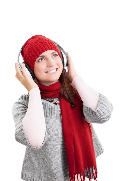 Usmívající se dívka v zimních šatech se sluchátky — Stock fotografie