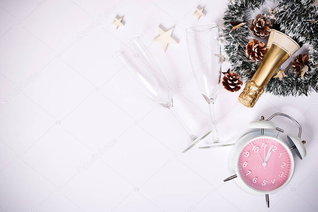 Champagne bottle with two glasses, decoration and clock