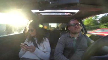 Çift gülüyor ve araba sürüş sarılma
