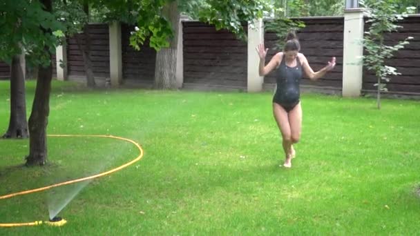 View Wet Pregnant Woman Running Rain Sprinkler — Stock Video