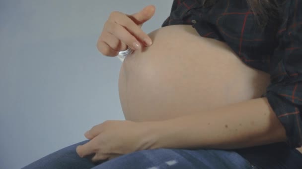 Pregnant woman caressing her belly. — Stock Video