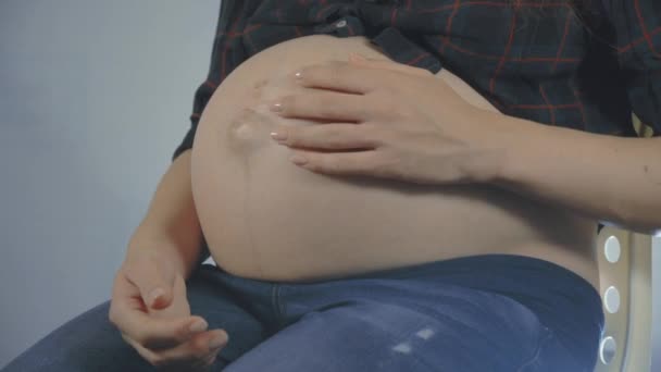 Schwangere streichelt ihren Bauch. — Stockvideo