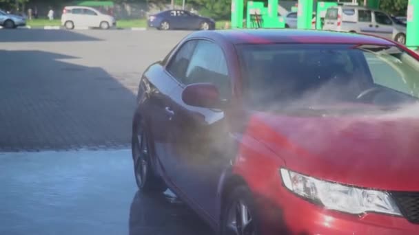 Kaukasische jongeman wassen van zijn auto op de Autowassen selfservice. Auto wassen. — Stockvideo