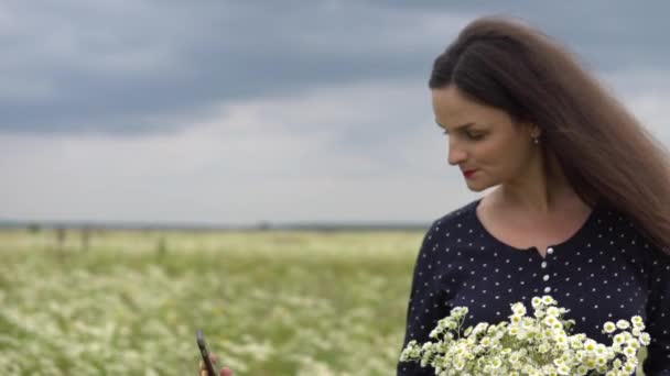 Krásná holka dělá selfie, Foto s květy heřmánku mimo. — Stock video