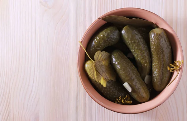 Pickled cucumbers in a bowl on a wooden surface. Close-up. Place for text. — Stock Image Pickled cucumbers in a bowl on a wooden surface. Close-up. Place for text. Stock Picture