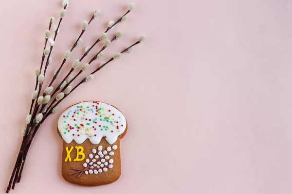 Gingerbread in the shape of a cake and willow twigs. Sweets for celebrating Easter.