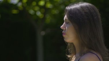 Yakın çekim yogi kadın lotus pozisyonu park yüz eller içinde meditasyon rahat oturuyor
