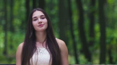 Sakin kendine güvenen genç kadın içine kamera yavaş ormandaki açık görünüyor