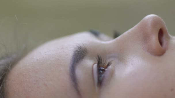 女性の顔のクローズ アップ うつ病の壊れた関係を横になっている 女性の点滅の目 — ストック動画